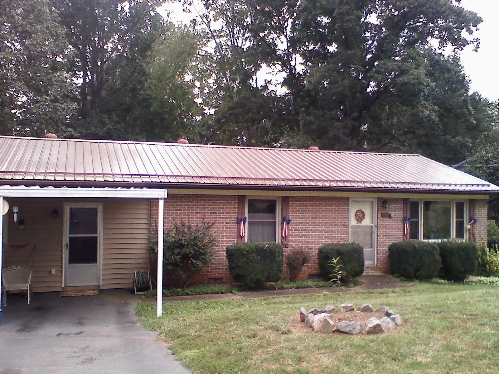 Bronze metal roof and carport on a brick ranch home — Roof Repair work by our crew in Chino Hills